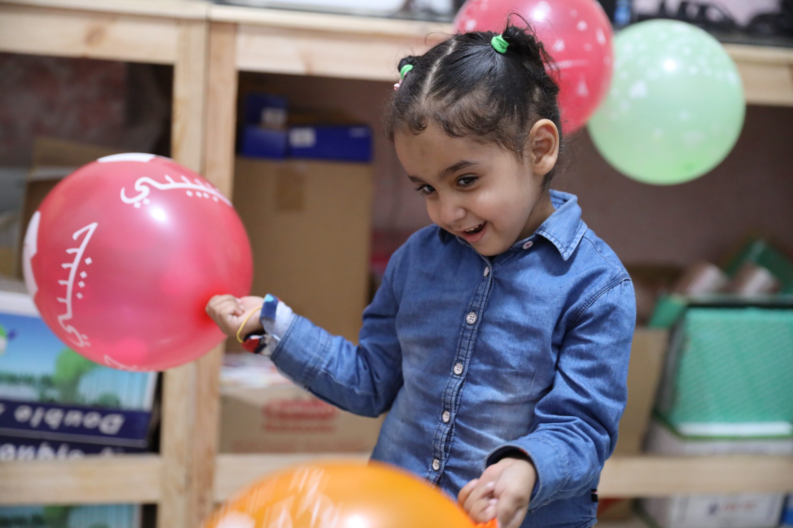 Child playing with colorful balloons inside a kids friendly mall in gurgaon